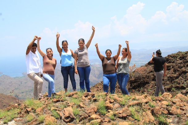 The mothers of the children in the program reach the top of the high remote Cerro Ingles and celebrate, with the view all around